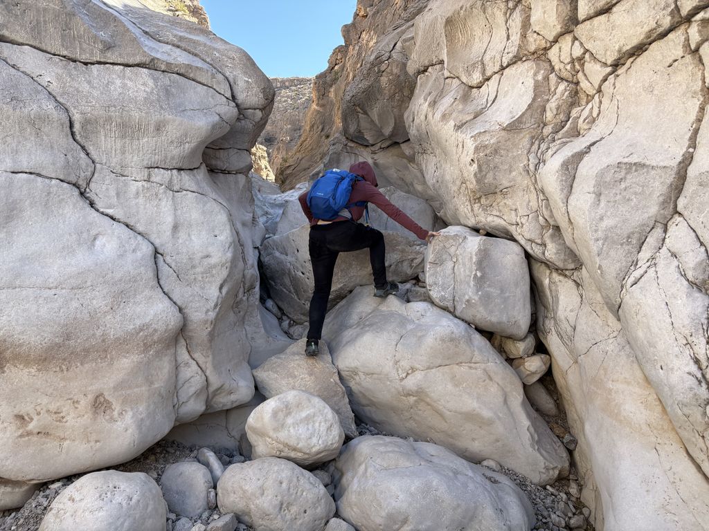 Scout climbing rocks.