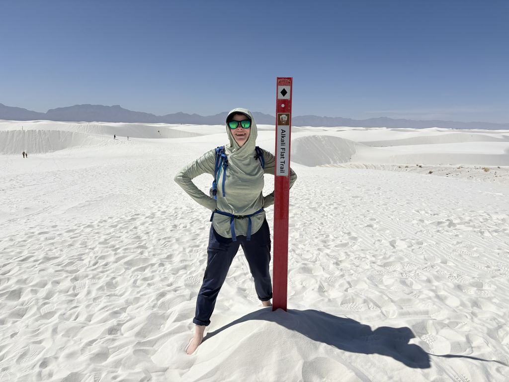 Scout at a trail marker for the Alkali Flat Trail.