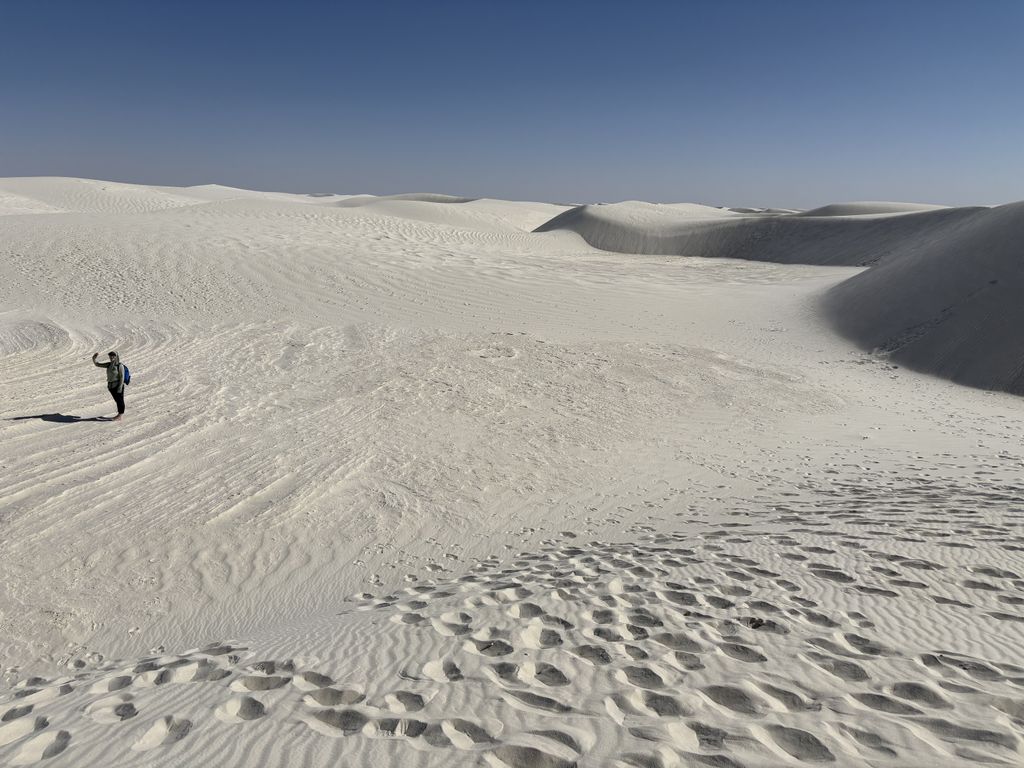 Scout waving from the bottom of the dune.